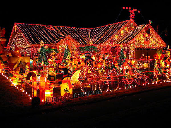 House and yard covered in Christmas lights and decorations